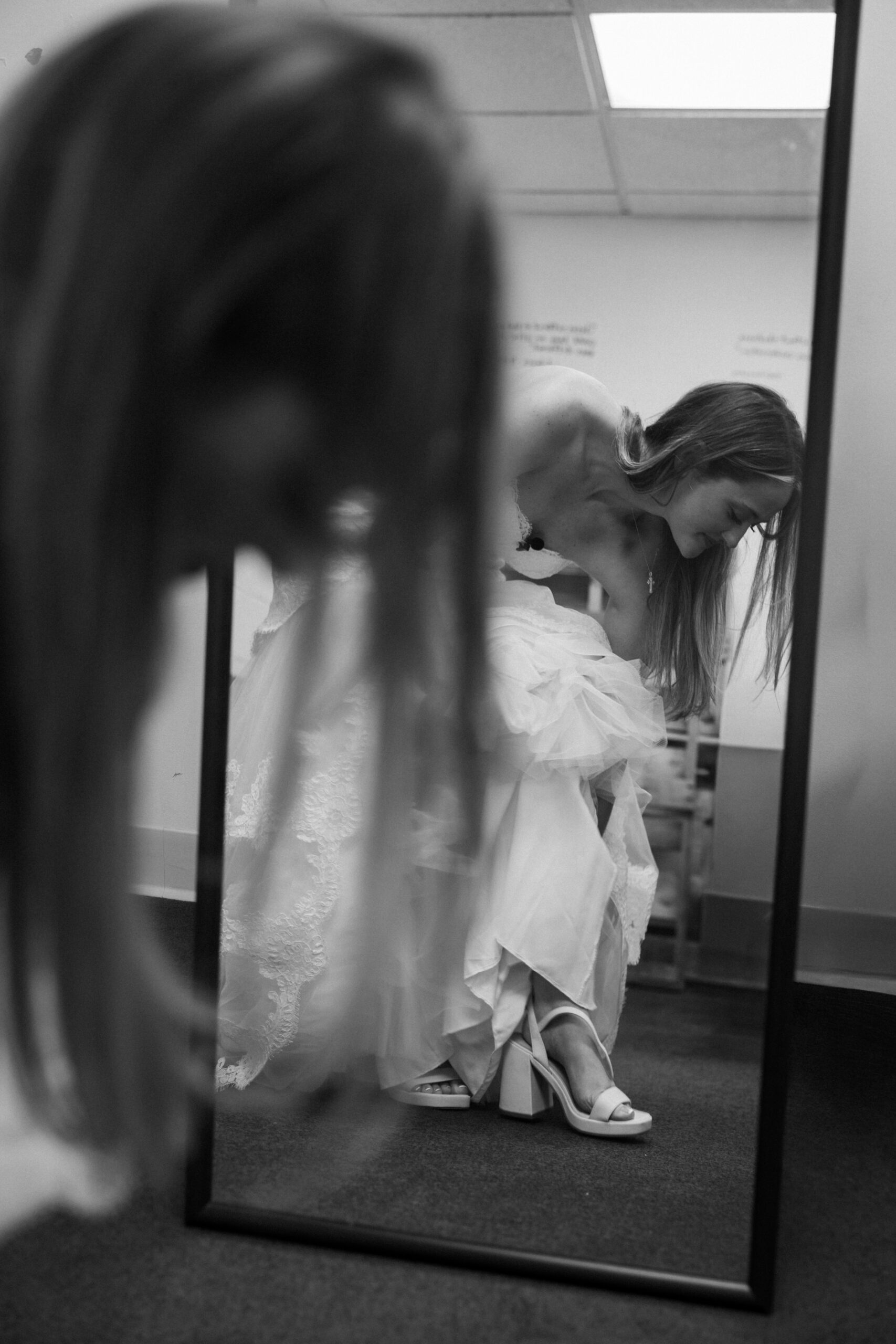 A bride putting on her wedding shoes.