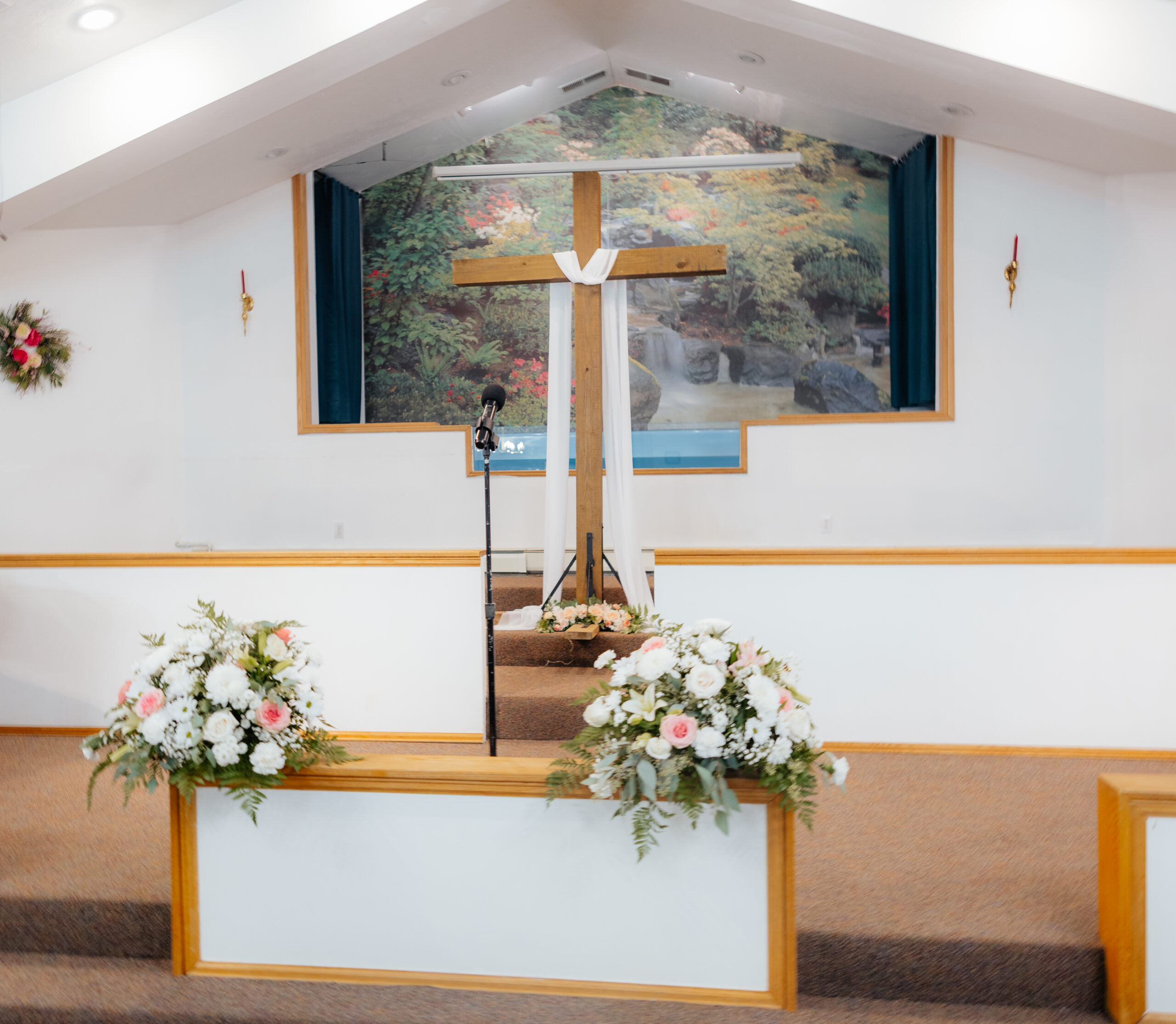 A cross with flowers in a church.
