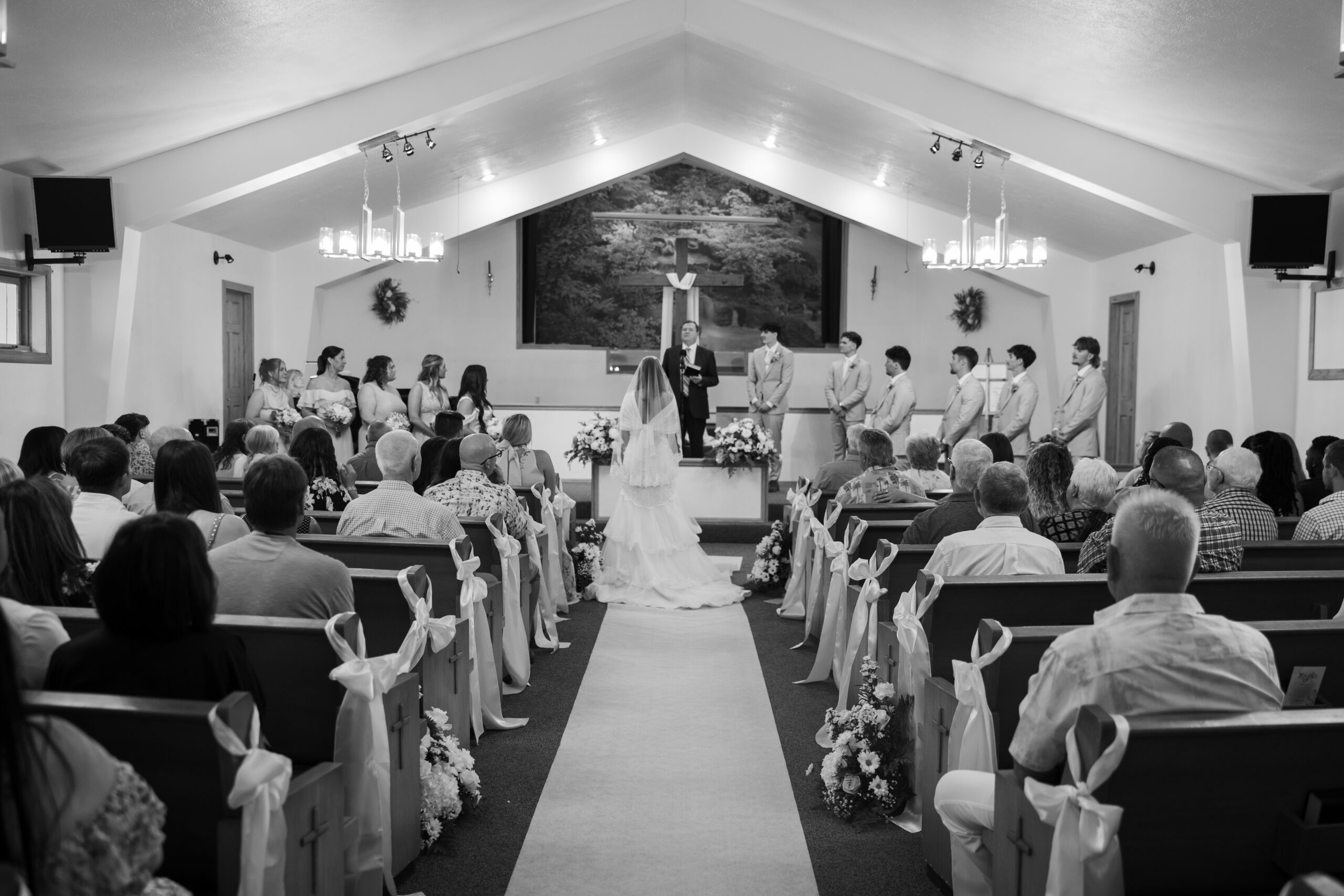 A church full of people at a wedding ceremony.