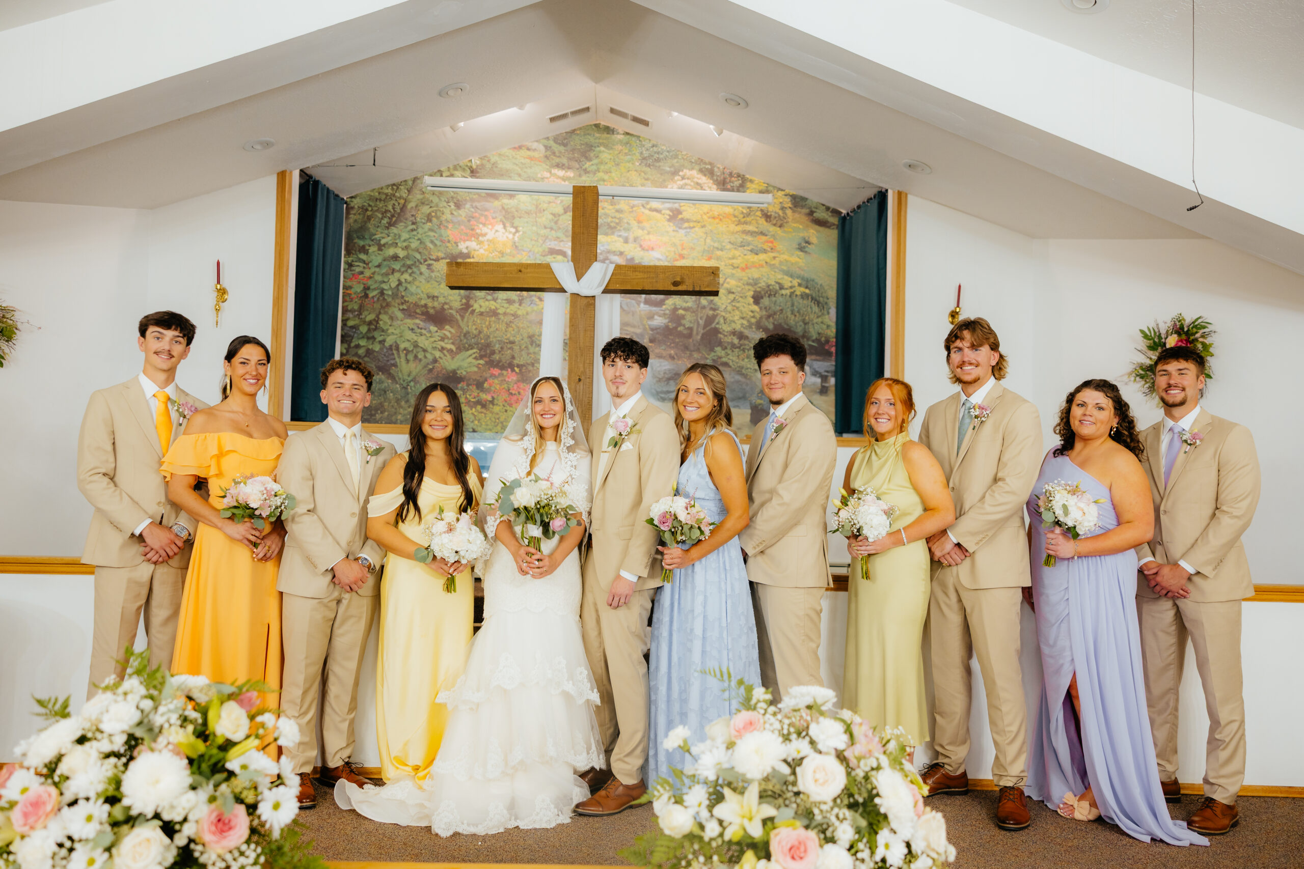 A bride and groom and their wedding party posing.