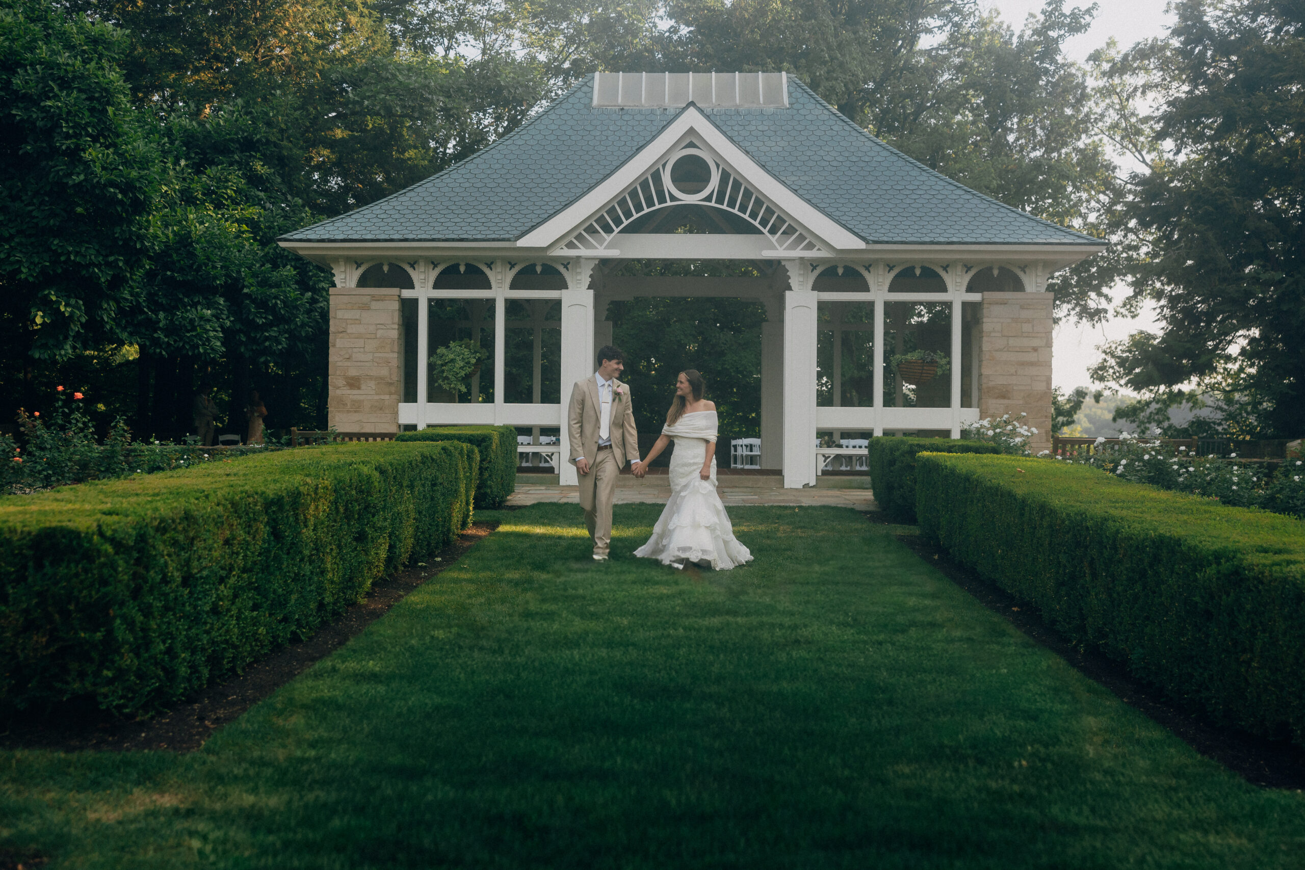 A bride and groom under a gazebo.